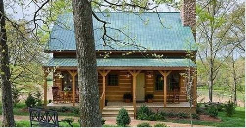 Something special awaits behind the doors of this custom Clayton Log Cabin